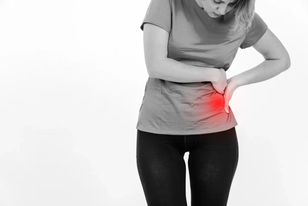 A woman having pain due to Hernia, tips on how to reduce risk of developing Hernia